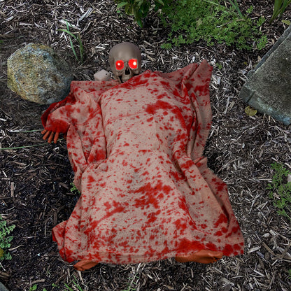 Voice-activated Halloween corpse prop with glowing hair and blood cloth for spooky decoration