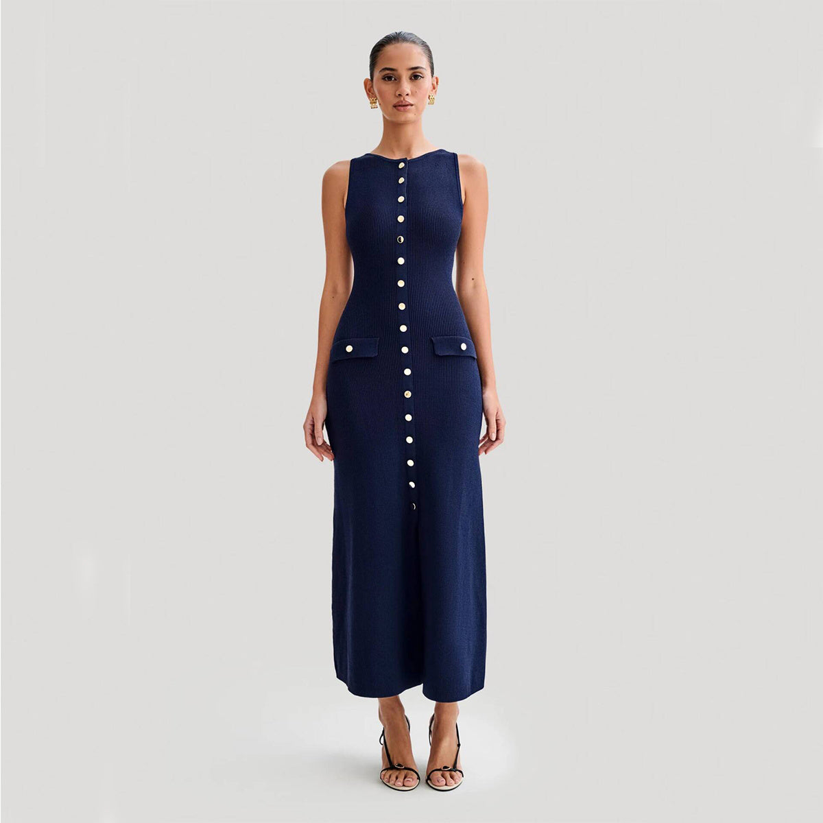 Elegant knitted sleeveless dress for women, featuring a slim fit, round neck, and single-breasted design. Long fashion dress in a chic style.