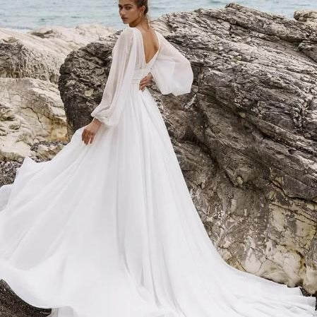 High Waist Plus Size Wedding Dress with Deep V-Neck, Long Sleeves, Backless Design, and High Slit for a sophisticated bridal look.