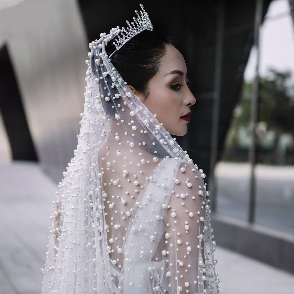 Luxury Heavy Wedding Dress with a Bridal Pearl Veil, offering an elegant and sophisticated look perfect for her special day.