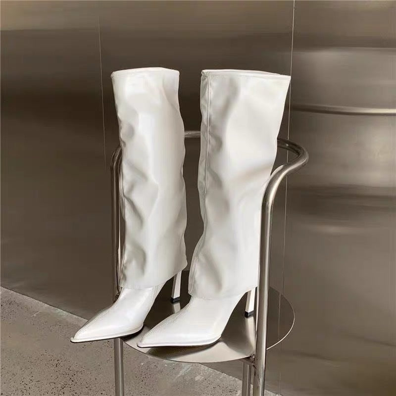 Patent leather pointed toe pantyhose boots with stiletto high heels, offering a bold and elegant look for women's fashion.