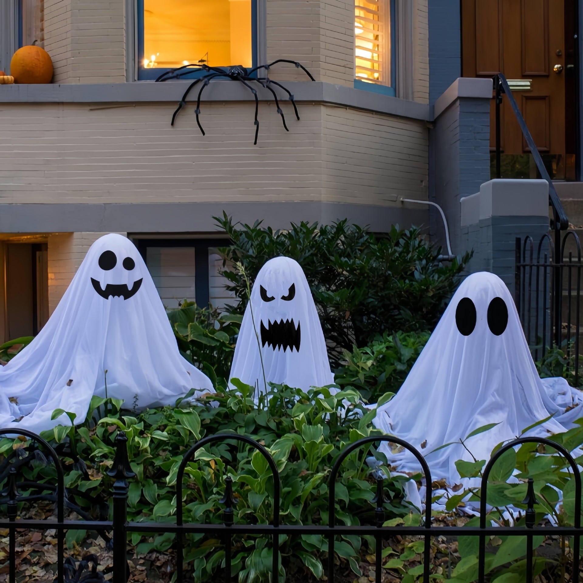 "Ghost Halloween decorations for front porch and courtyard, spooky outdoor decor, haunting ghost figures, Halloween yard decorations, eerie Halloween setup."