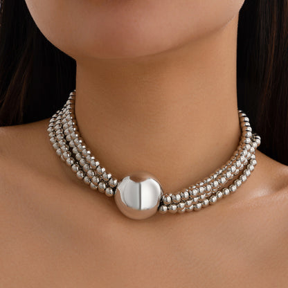 European American multi-layer necklace featuring a bold ball pendant