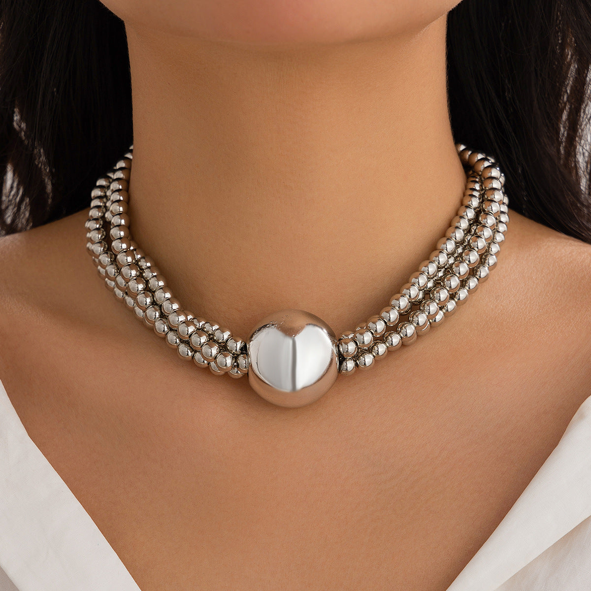 European American multi-layer necklace featuring a bold ball pendant